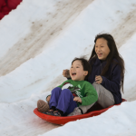 boy and girl sledding
